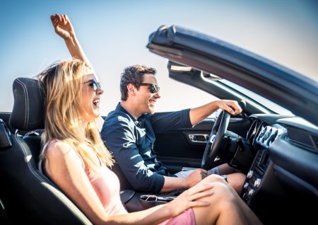 Couple of lovers driving on a convertible car - Newlywed pair on a romantic date